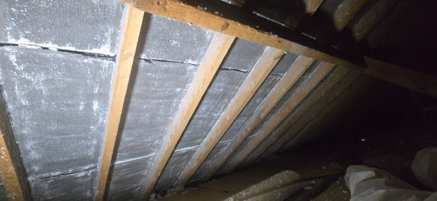 Close-up of roof timbers after spray foam insulation removal work