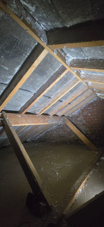 Spray foam removal specialist work on a pitched roof, UK property