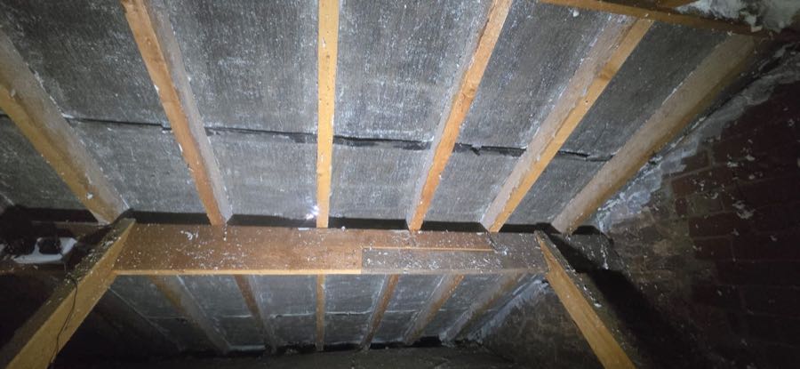 Close-up of roof timbers after spray foam insulation removal work