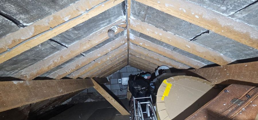Spray foam removal specialist work on a pitched roof, UK property