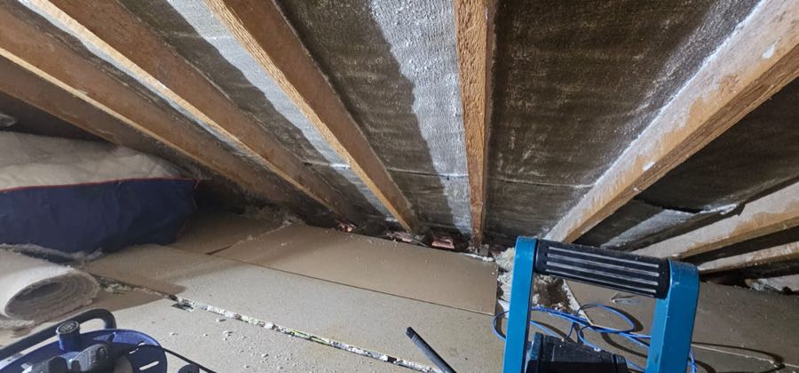Loft insulation and roof felt exposed after spray foam removal