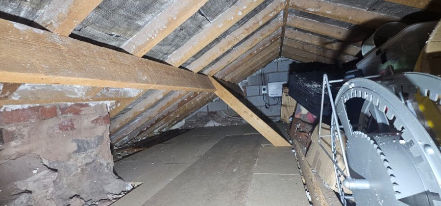 Close-up of roof timbers after spray foam insulation removal work