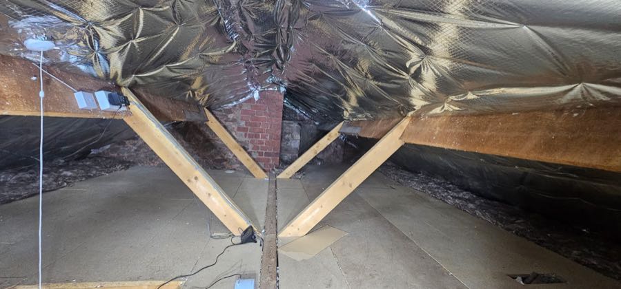 Roof void cleared of spray foam insulation, ready for re-roofing