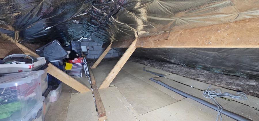 Spray foam removal specialist work on a pitched roof, UK property