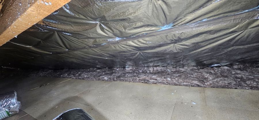 Loft insulation and roof felt exposed after spray foam removal